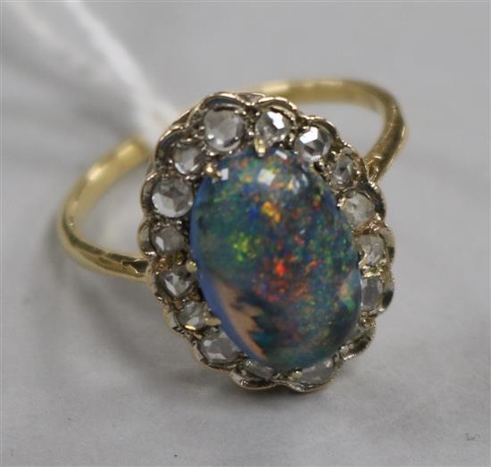 A yellow metal, opal and diamond oval cluster ring, size O.